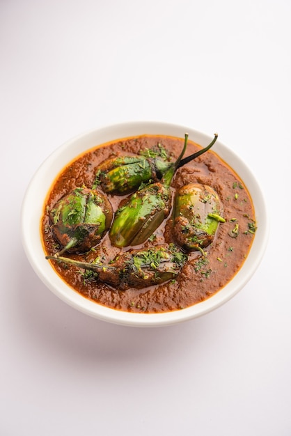 Brinjal curry also known as spicy baingan or eggplant masala, a popular main course recipe from India served in a bowl, karahi or pan