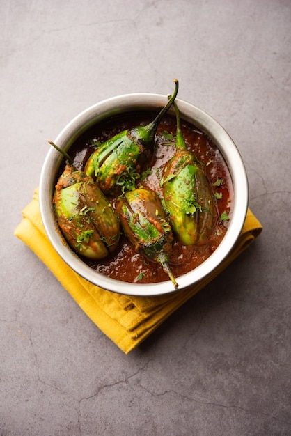 Brinjal curry also known as spicy baingan or eggplant masala, a popular main course recipe from India served in a bowl, karahi or pan