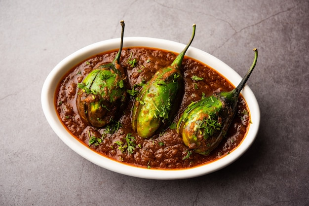 Brinjal curry also known as spicy baingan or eggplant masala, a popular main course recipe from India served in a bowl, karahi or pan