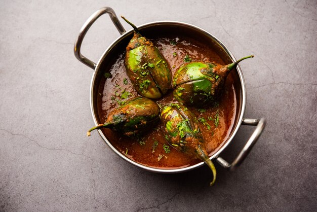 Brinjal curry also known as spicy baingan or eggplant masala, a popular main course recipe from India served in a bowl, karahi or pan