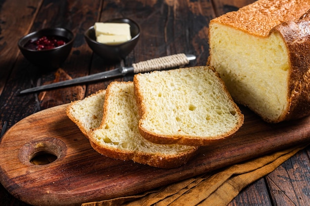 Brioche bread on breakfast table with butter and jam Wooden background Top view