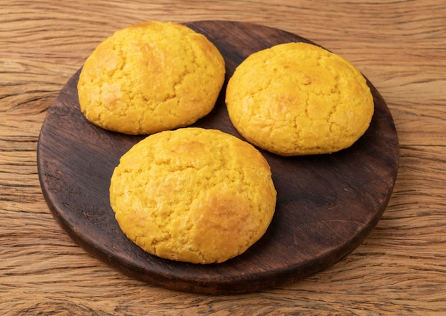 Broa typical brazilian corn flour bread over wooden board