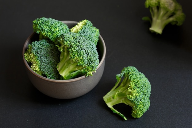 Broccoli in the bowl at black.