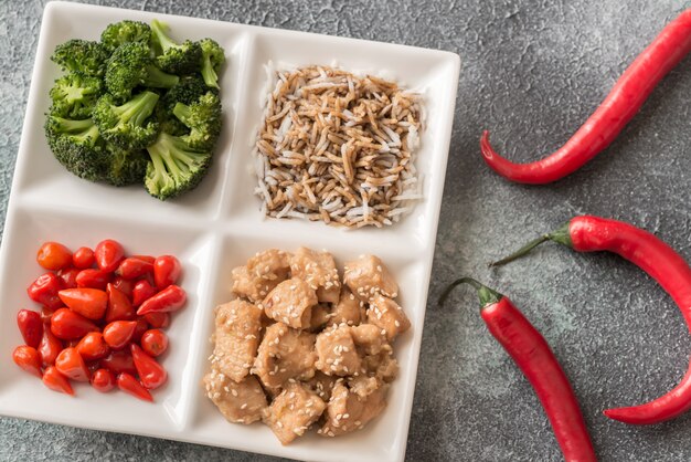 Broccoli and chicken stir-fry with rice and chili