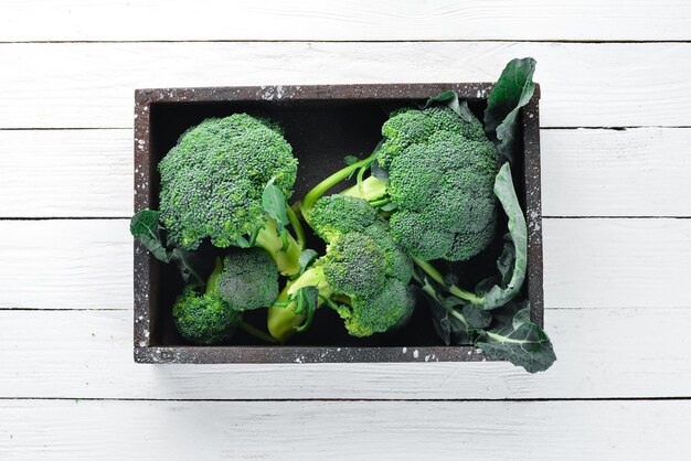 Broccoli Fresh green broccoli on a white wooden table Top view Free copy space