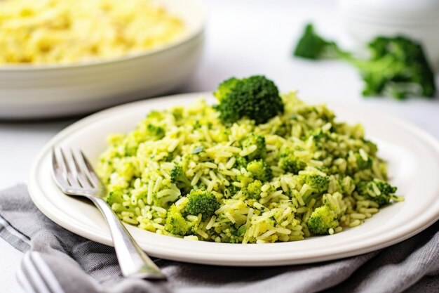 Broccoli rice in a white ceramic plate with silver fork