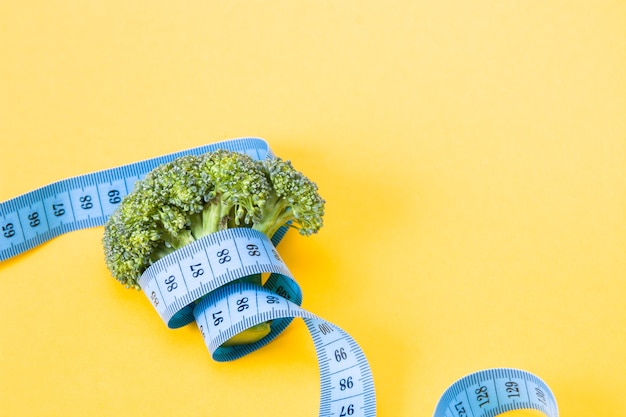 broccoli with a blue measuring tape