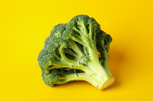 Broccoli on yellow, close up. Healthy food