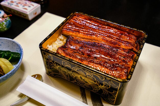 Broiled eel served over rice in a lacquered box