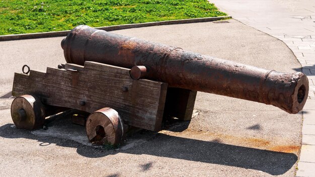 Broken abandoned ancient medieval artillery cannon on a wooden cart with wheels