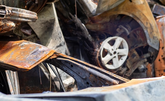 Broken and burned cars in the parking lot accident or deliberate vandalism Burnt car Consequences