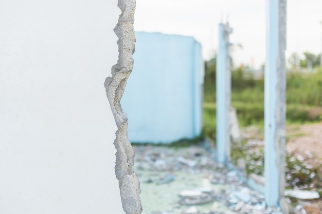Broken cement wall in process of break house on blur