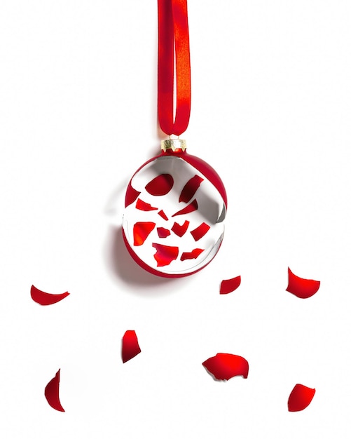 Broken Christmas ball red colored pattern with fragments of festive New Year glass ball