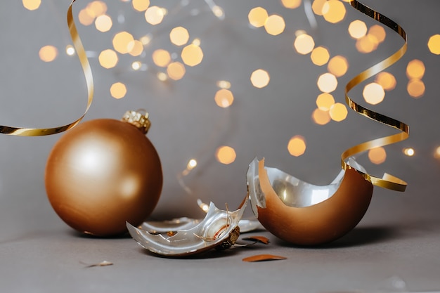 Broken Christmas balls with ribbons and bokeh lights