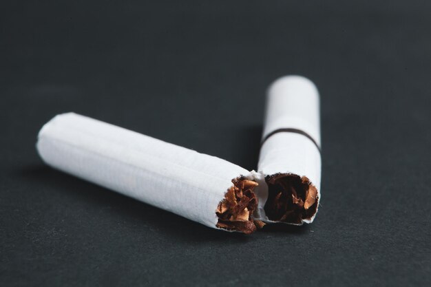 Broken cigarette on dark background