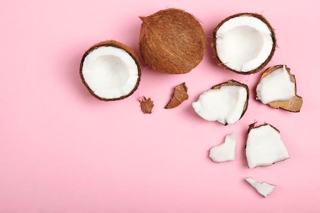 Broken coconut on a colored background closeup