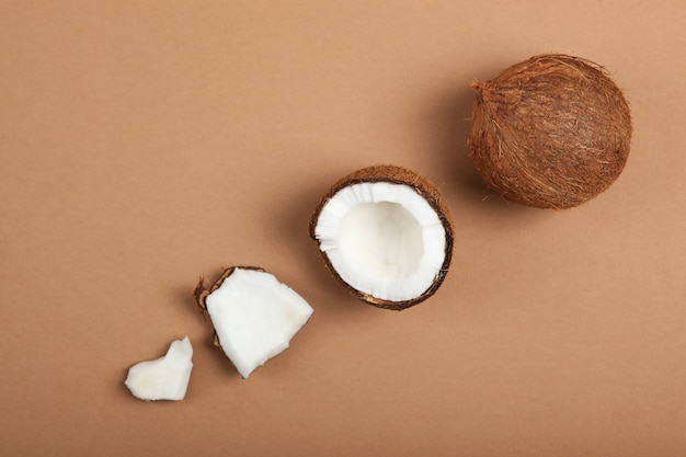 Broken coconut on a colored background closeup