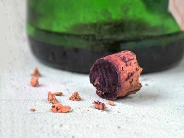 The broken cork from the old wine is on the table.