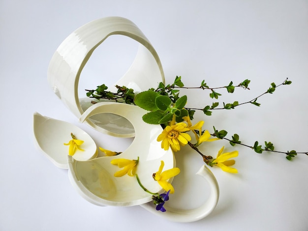 Broken cup and spring flowers relationship concept divorce renewal still life copyspace