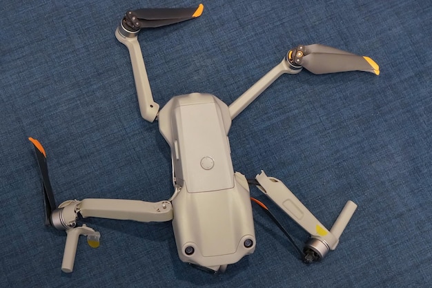 Broken drone after a fall with torn cables and a broken camera isolated on a white background