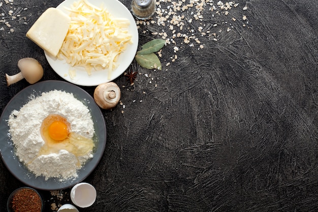 Broken egg on flour in a plate