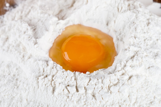 Broken egg on flour 