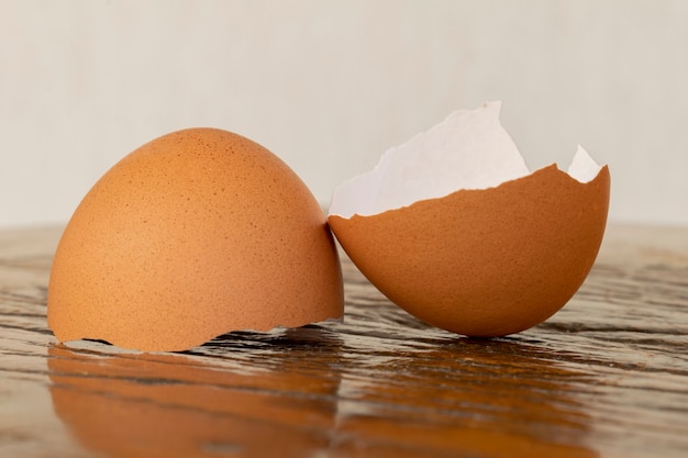 Broken eggshell on the rustic table.