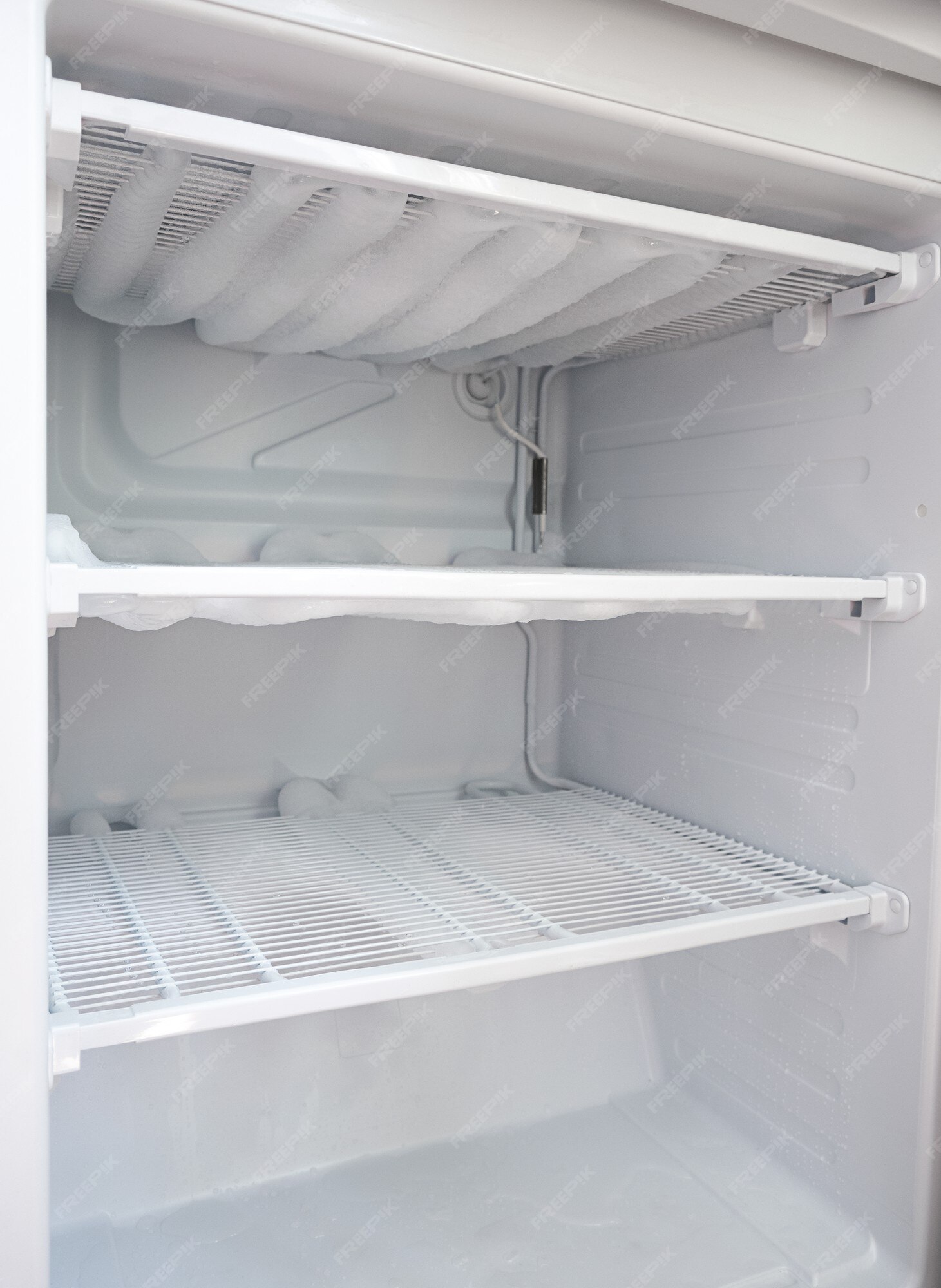 Premium Photo Broken fridge. snow on freezer shelves. defrosting the