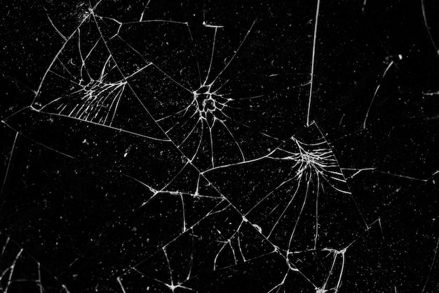 Photo broken glass black background texture, cracked touch screen phone.