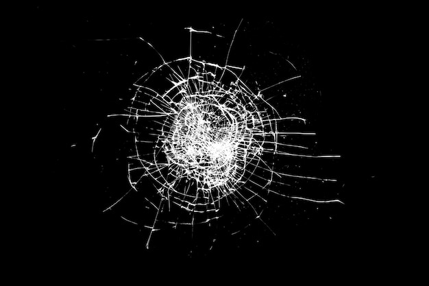 Broken glass is insulated against a black background. white cracks.