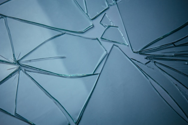 Broken glass pile pieces of texture and background isolated on white, cracked window effect. Emergency condition.