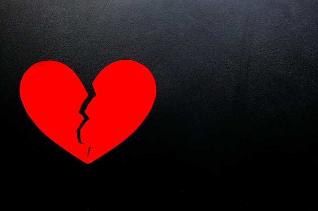 Premium Photo | Broken heart made from red paper on black background,  represent love.