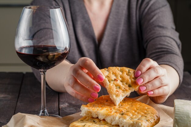 Broken loaf of bread and glass of red wine