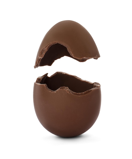 Broken milk chocolate egg on white background