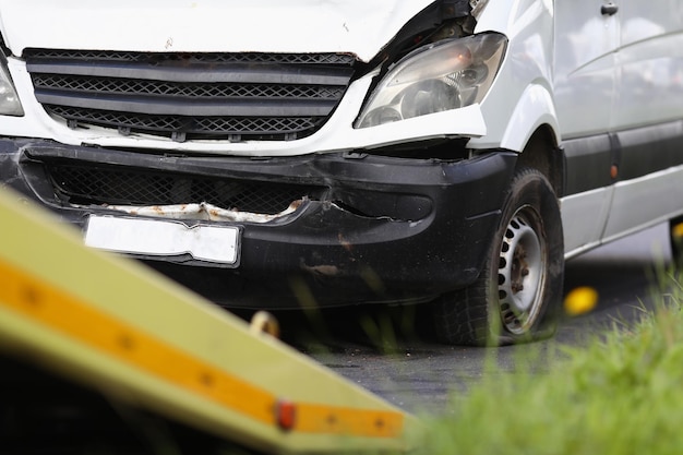 Broken minibus stands on road after an acciden