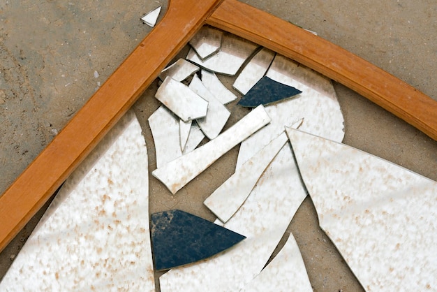 Broken mirror with wooden frame background