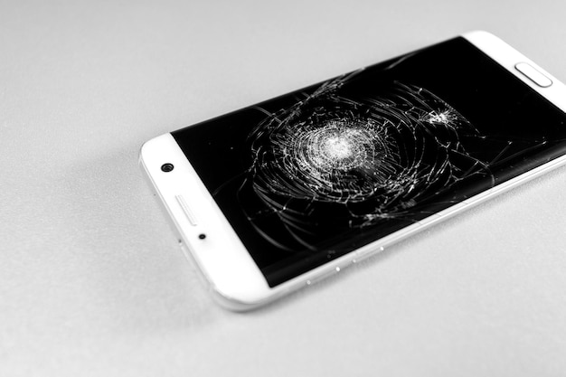 Broken mobile phone display on a white background