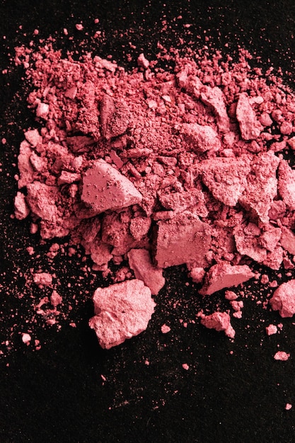 Broken pink blush on black table