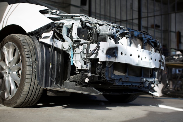 Broken white car in the garage