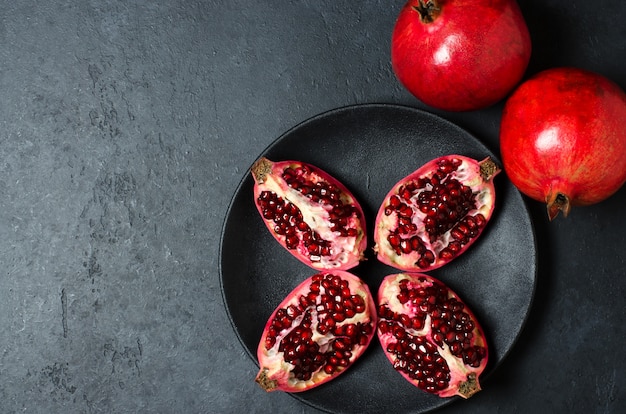 Broken and whole pomegranate fruit