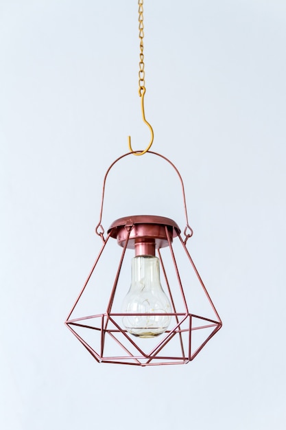 Bronze color industrial geometrical lamp on a white background