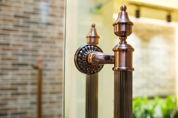 Bronze door handle on glass doors. transparent doors