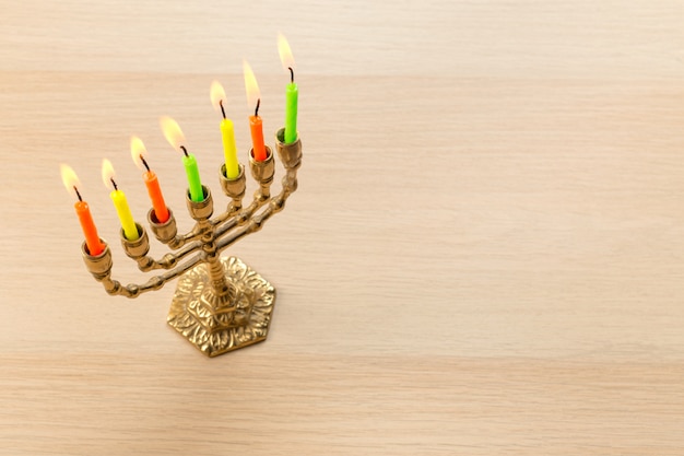 Bronze Hanukkah menorah with burning candles