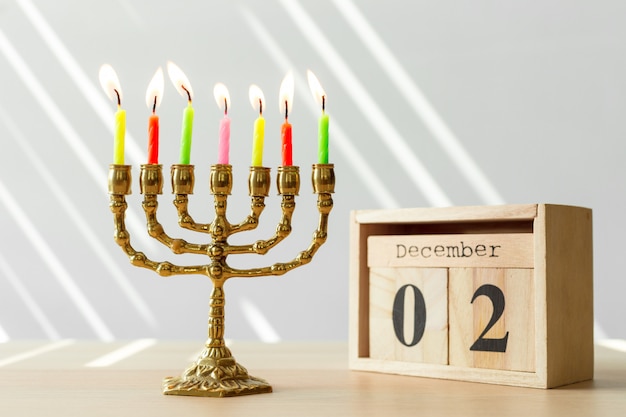 Bronze Hanukkah menorah with burning candles