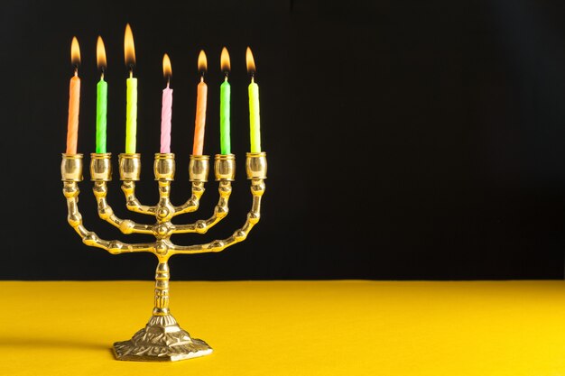 Bronze Hanukkah menorah with burning candles