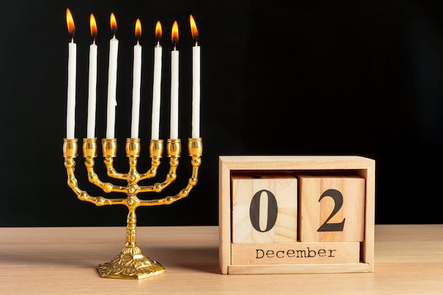 Bronze Hanukkah menorah with burning candles