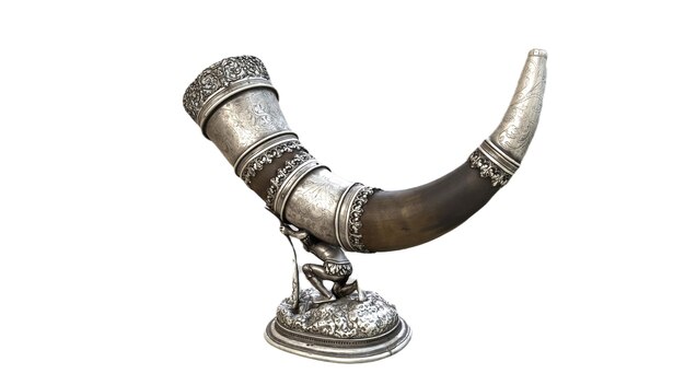 A bronze horn with a design on it