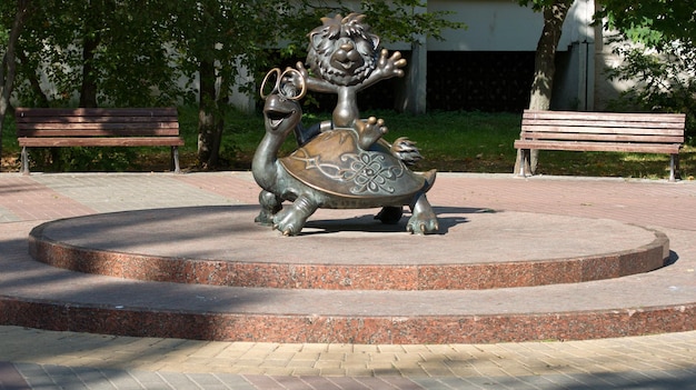 Bronze sculpture of cartoon charactersa turtle and a lion cub