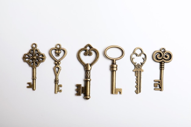 Bronze vintage ornate keys on white background top view