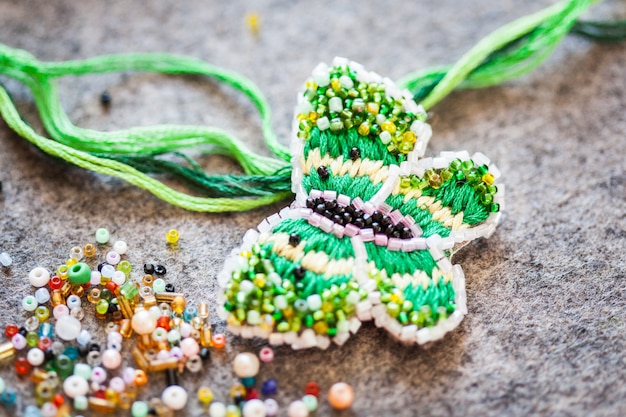 Photo brooch made of beads and thread